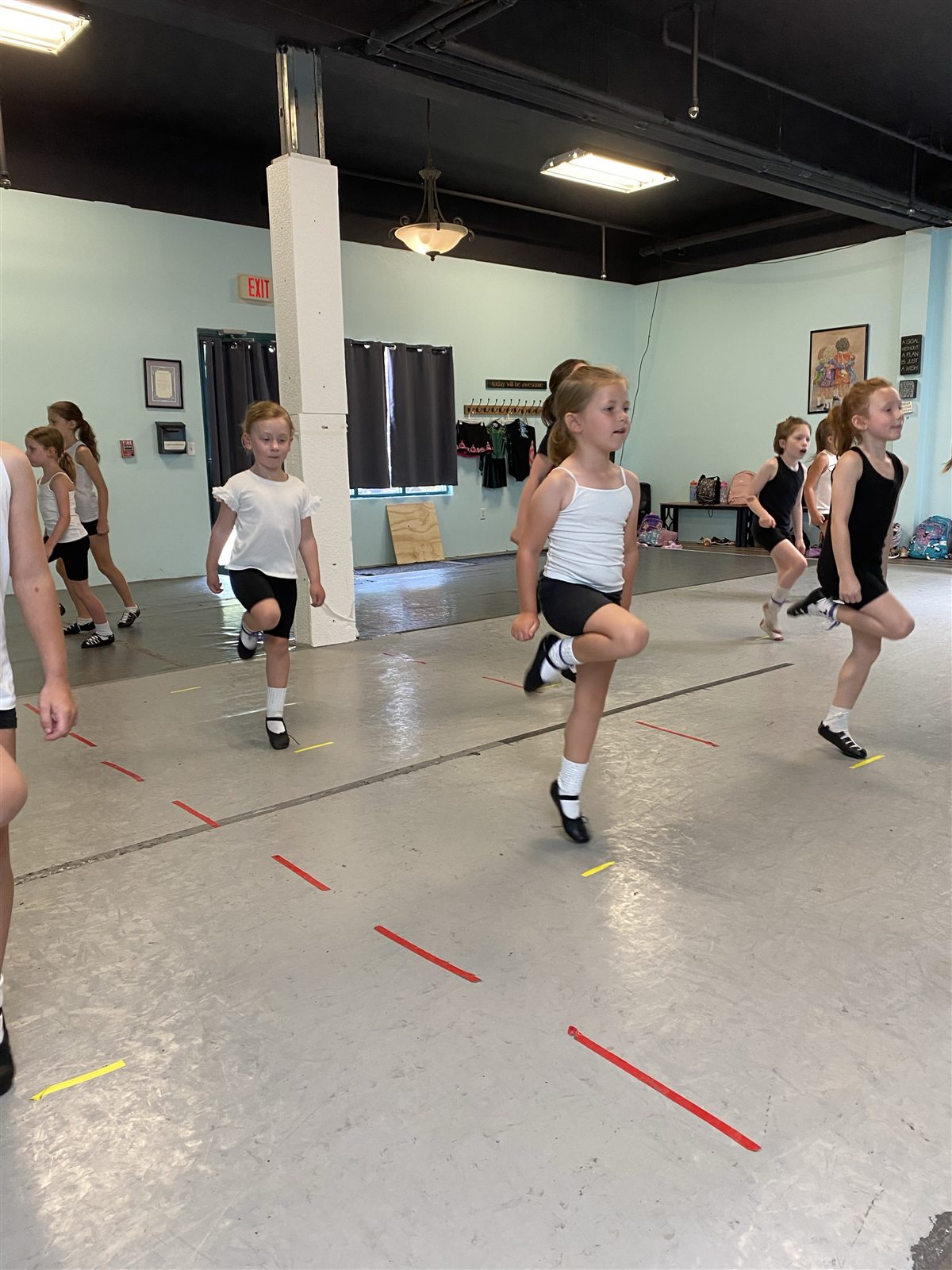 Young dancers practicing steps together in the studio