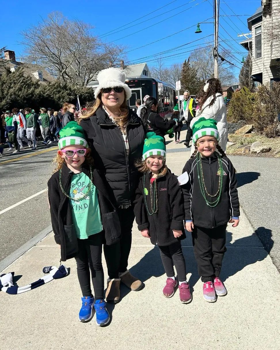 Spirited Soles dancers in green hats at a St. Patrick's Day parade